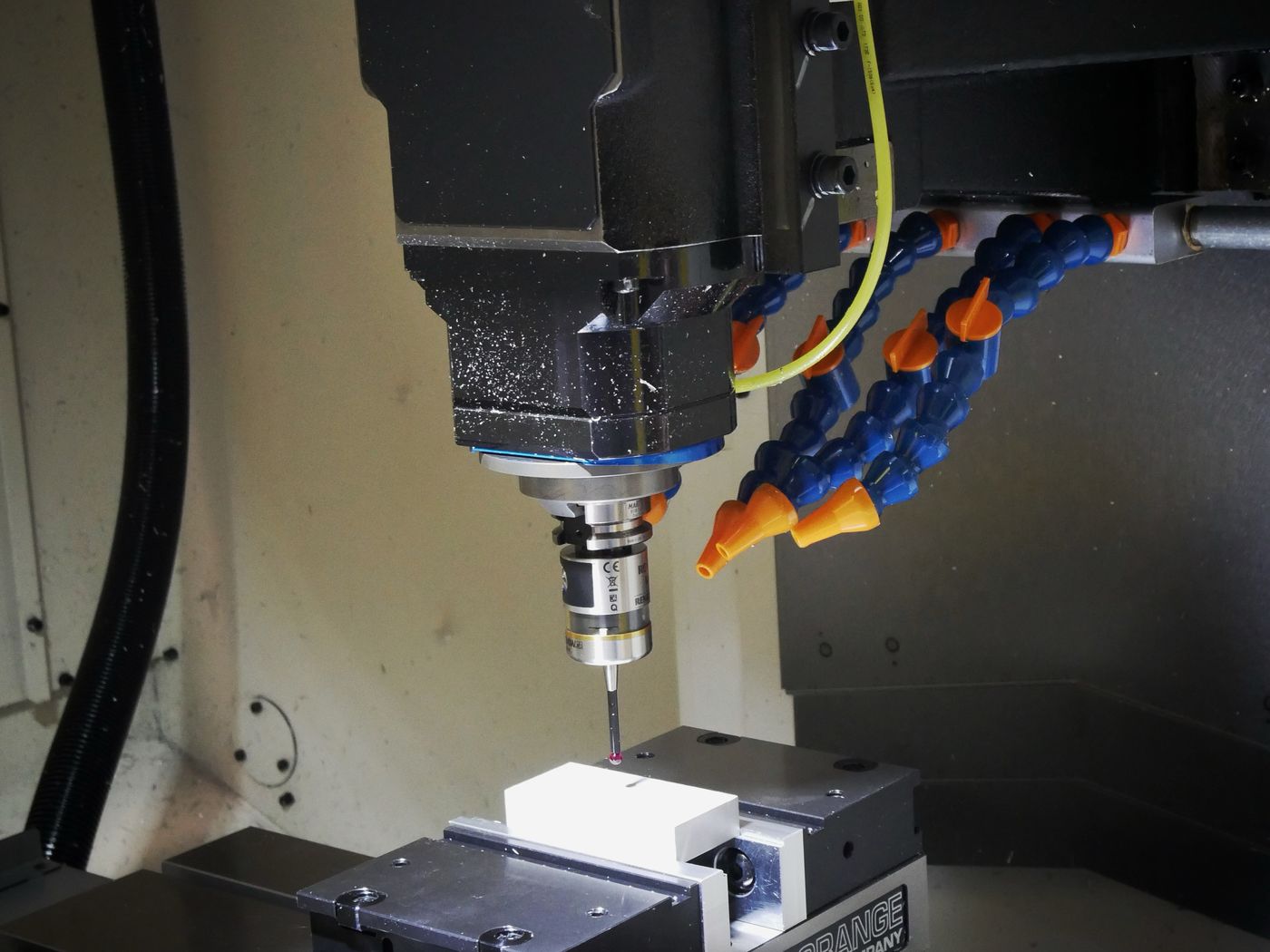 Spindle and coolant lines over a part clamped in the machine vise